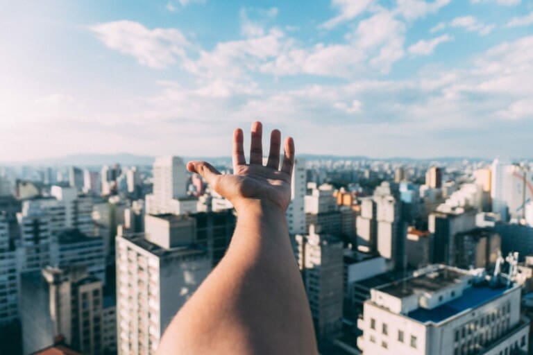 hand-w-skyline-scaled-1