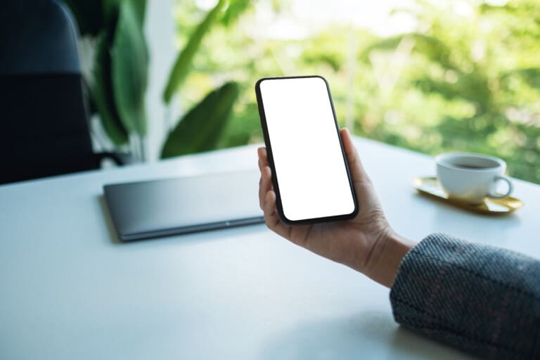Mockup image of a business woman holding mobile phone with blank