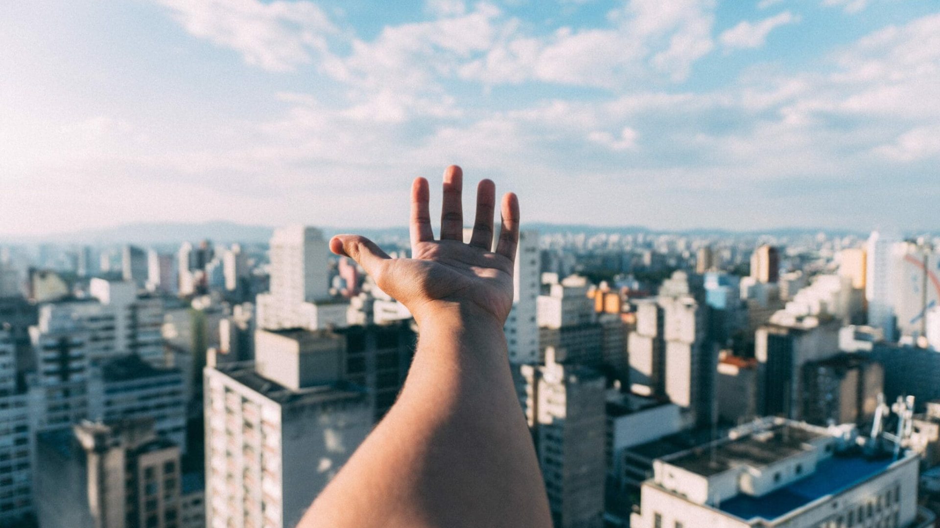 hand-w-skyline-scaled-1